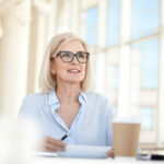 Confident mature business woman leader coach speaking at meeting